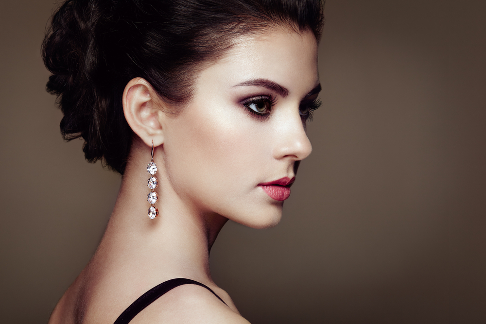 woman with gem earrings