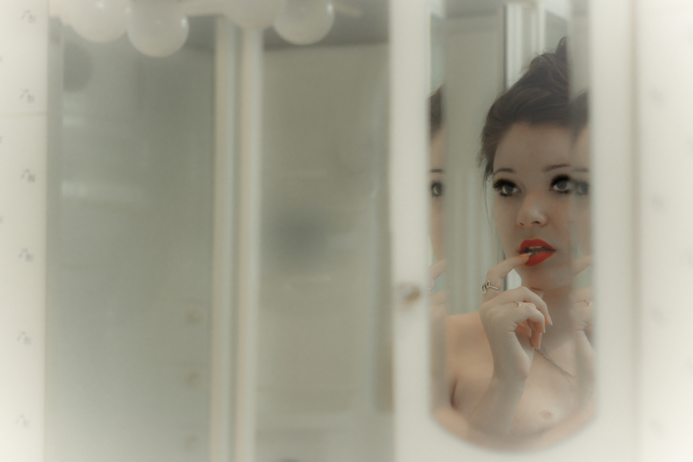 woman looking at foggy mirror