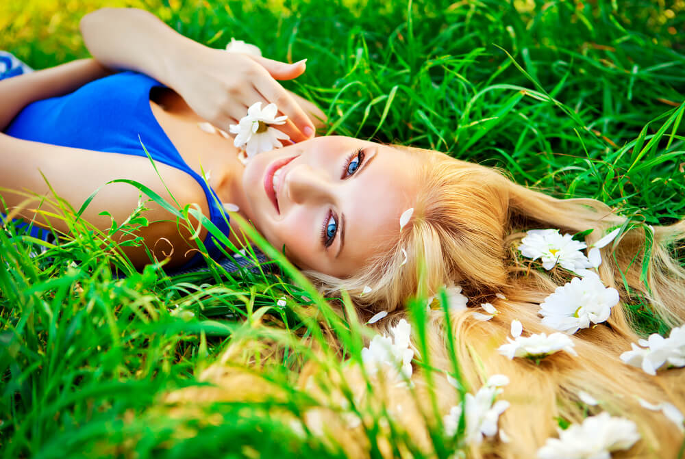 woman with flowers in hair on grass